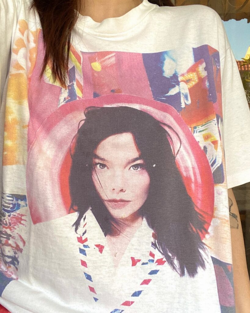 Oversized white t-shirt with a large colorful graphic print of a woman's face.