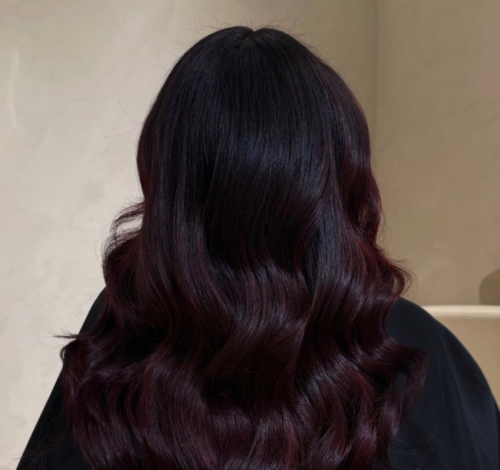 Long wavy hair dyed in a deep black cherry red burgundy shade.