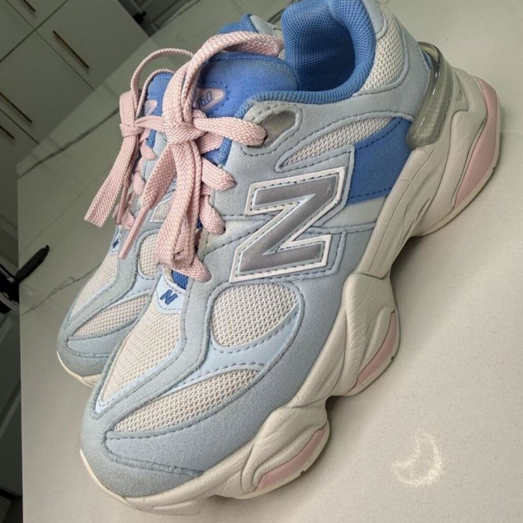 Light blue and pink New Balance 9060 sneakers with a chunky white sole.