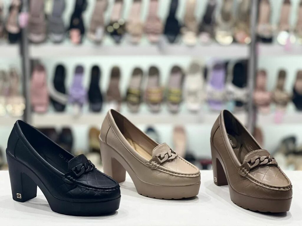 Three platform loafers with low block heels in black, beige, and brown colors.